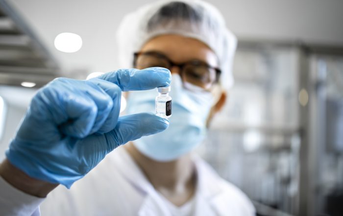 Technology Transfer specialist holding vial of medicine