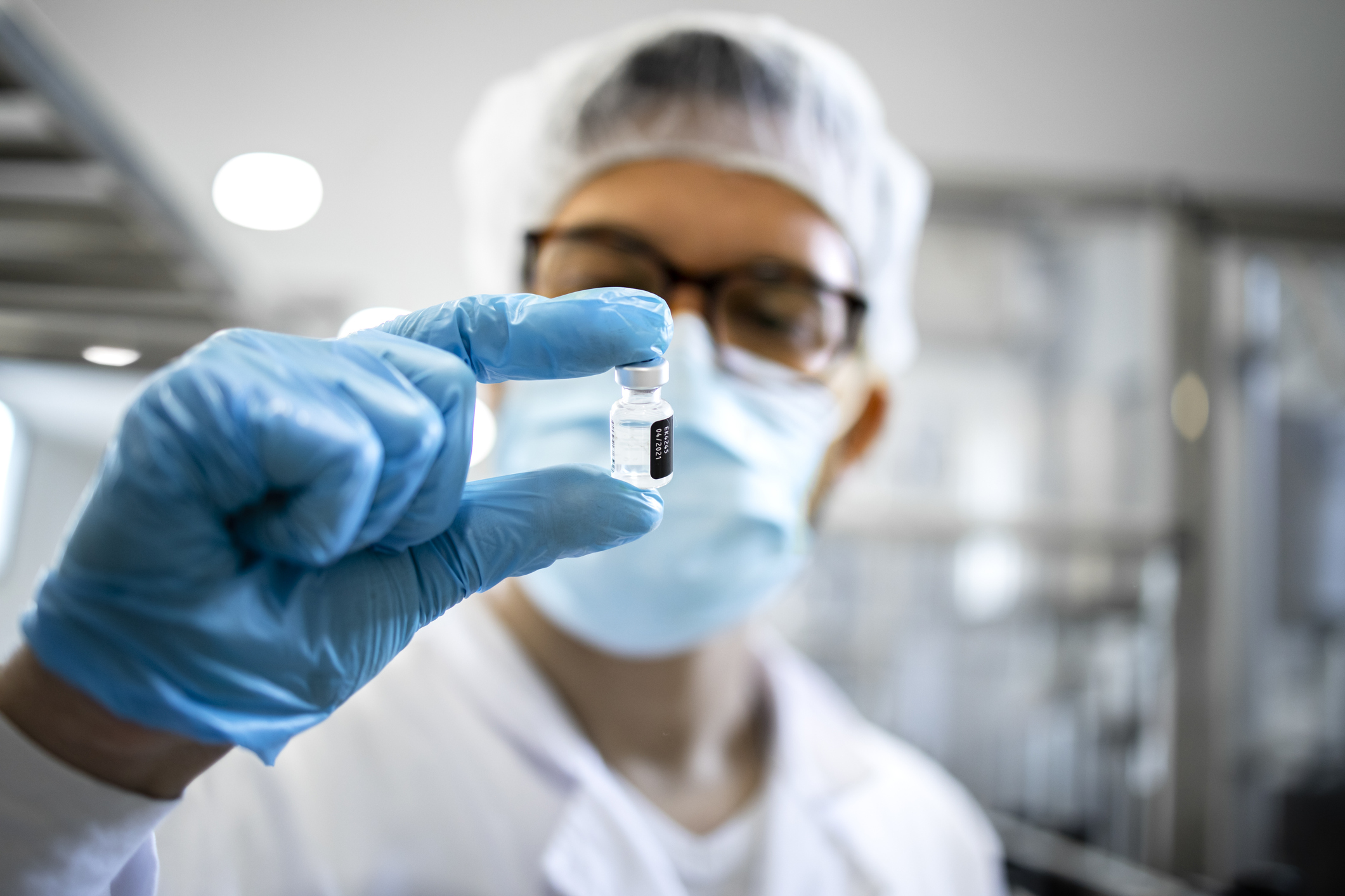 Technology Transfer specialist holding vial of medicine